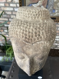 A Thai sandstone head of Buddha, possibly Ayutthaya period, 14/15th C.