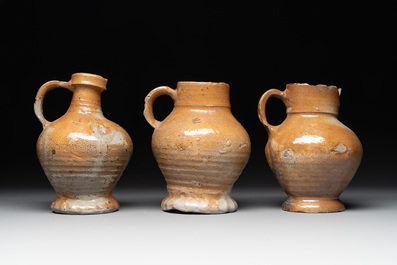 A collection of 13 German stoneware jugs, 15th C. and later