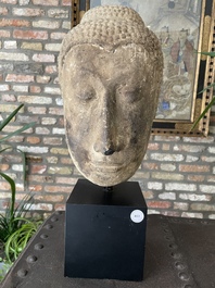 A Thai sandstone head of Buddha, possibly Ayutthaya period, 14/15th C.