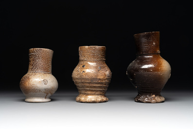 A collection of 13 German stoneware jugs, 15th C. and later