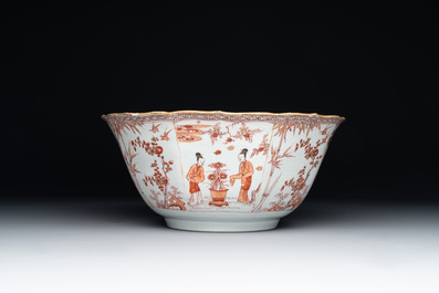 A Chinese iron-red and gilt-decorated 'ladies in a garden' bowl, Kangxi