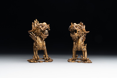 A pair of Chinese gilt bronze dragons among flames and clouds, 19/20th C.