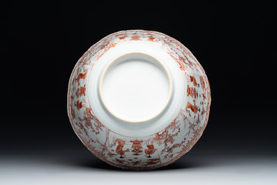 A Chinese iron-red and gilt-decorated 'ladies in a garden' bowl, Kangxi