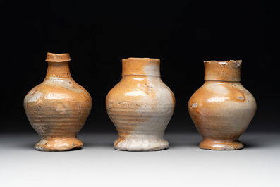 A collection of 13 German stoneware jugs, 15th C. and later