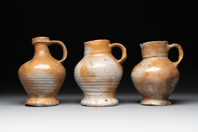 A collection of 13 German stoneware jugs, 15th C. and later