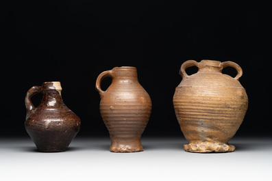 A collection of 13 German stoneware jugs, 15th C. and later