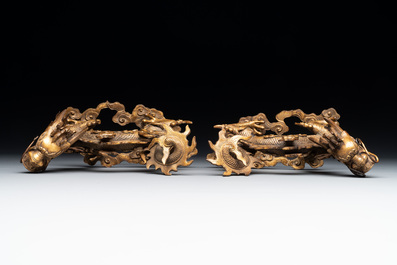 A pair of Chinese gilt bronze dragons among flames and clouds, 19/20th C.