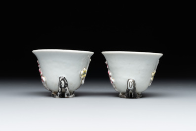 A pair of Chinese Dehua blanc de Chine relief-decorated famille rose 'prunus' cups, 19th C.