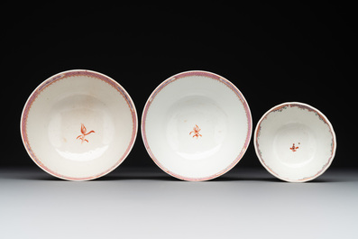 A Chinese famille rose 'Lowestoft' teapot, a plate, three cups and nine saucers, Qianlong