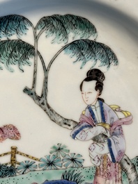 A pair of Chinese famille rose 'ladies in a garden' plates, Yongzheng
