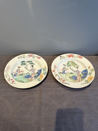 A pair of Chinese famille rose 'ladies in a garden' plates, Yongzheng