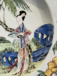 A pair of Chinese famille rose 'ladies in a garden' plates, Yongzheng