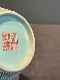 A Chinese iron-red-decorated turquoise-ground bottle vase with bats, Qianlong mark, 20th C.