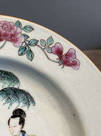 A pair of Chinese famille rose 'ladies in a garden' plates, Yongzheng