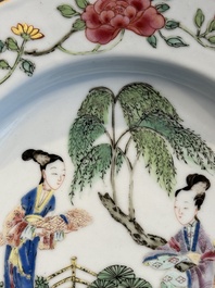 A pair of Chinese famille rose 'ladies in a garden' plates, Yongzheng