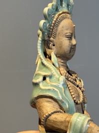 A Chinese Longquan celadon Guanyin, Ming or later