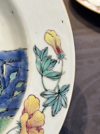 A pair of Chinese famille rose 'ladies in a garden' plates, Yongzheng