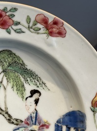 A pair of Chinese famille rose 'ladies in a garden' plates, Yongzheng