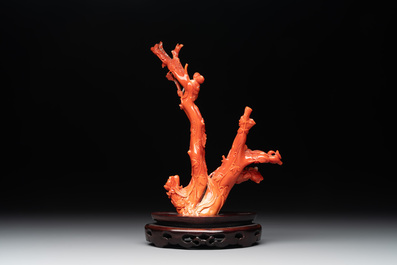 A Chinese carved red coral group with goddesses on wooden stand, 19/20th C.