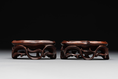 A pair of Chinese cherry amber or faturan recumbent oxen on wooden stands, Republic