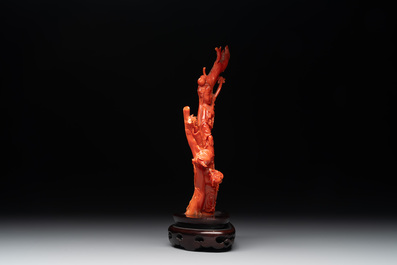 A Chinese carved red coral group with goddesses on wooden stand, 19/20th C.