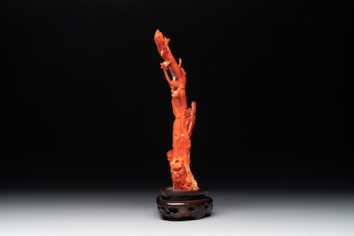 A Chinese carved red coral group with goddesses on wooden stand, 19/20th C.