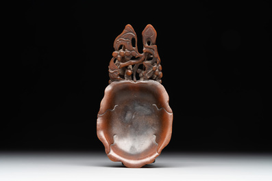 A rare Chinese carved rhinoceros horn 'libation cup' with grape design, 17/18th C.