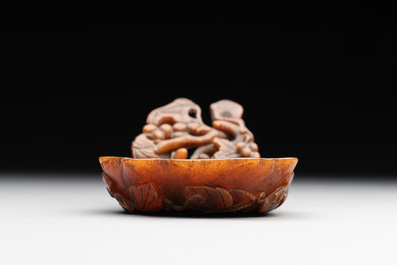 A rare Chinese carved rhinoceros horn 'libation cup' with grape design, 17/18th C.