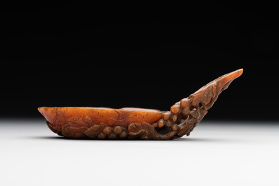 A rare Chinese carved rhinoceros horn 'libation cup' with grape design, 17/18th C.