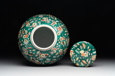 A pair of Chinese famille verte green-ground 'prunus' jars and covers, 19th C.
