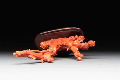 A Chinese carved red coral group with goddesses on wooden stand, 19/20th C.
