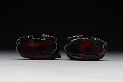 A pair of Chinese cherry amber or faturan recumbent oxen on wooden stands, Republic