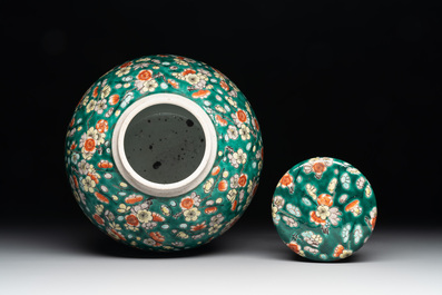 A pair of Chinese famille verte green-ground 'prunus' jars and covers, 19th C.
