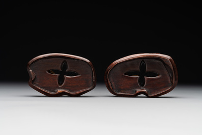 A pair of Chinese cherry amber or faturan recumbent oxen on wooden stands, Republic