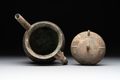 A Chinese inscribed archaic bronze tripod ritual wine vessel and cover, 'He 盉', Western Zhou