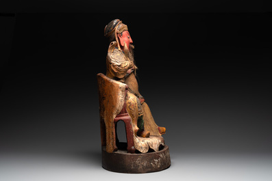 A large Chinese gilt- and polychromed wooden sculpture of a divinity, 19th C.