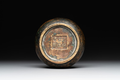 A small Chinese bronze bottle vase with lion-form handles, Qing, 17th C.