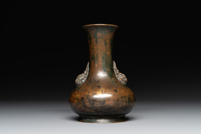 A small Chinese bronze bottle vase with lion-form handles, Qing, 17th C.