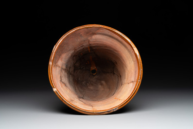Five pieces of glazed earthenware cooking utensils and a fire bell, probably The Netherlands, 17th C.