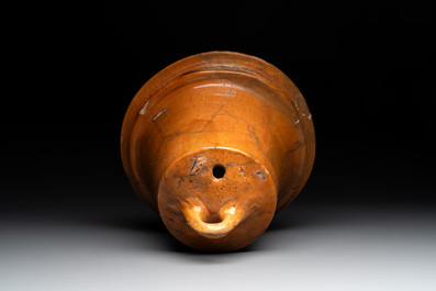 Five pieces of glazed earthenware cooking utensils and a fire bell, probably The Netherlands, 17th C.