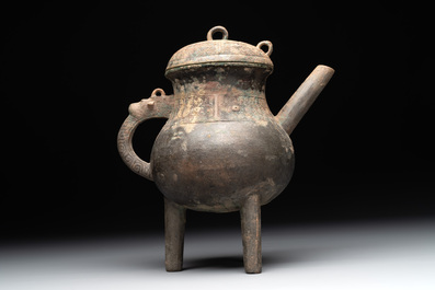 A Chinese inscribed archaic bronze tripod ritual wine vessel and cover, 'He 盉', Western Zhou