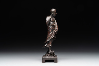 A fine Chinese bronze Luohan holding a sutra, Ming
