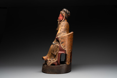 A large Chinese gilt- and polychromed wooden sculpture of a divinity, 19th C.