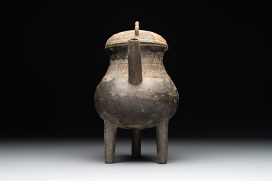 A Chinese inscribed archaic bronze tripod ritual wine vessel and cover, 'He 盉', Western Zhou