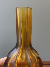 A Chinese facetted translucent amber-coloured Peking glass bottle vase, Qianlong mark, 19th C.
