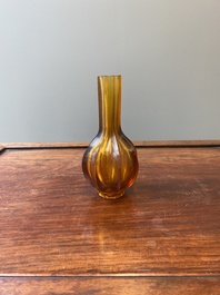 A Chinese facetted translucent amber-coloured Peking glass bottle vase, Qianlong mark, 19th C.