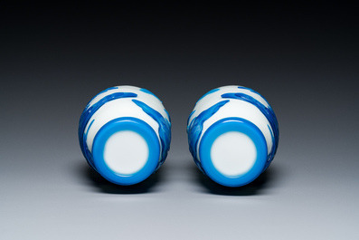 A pair of Chinese blue-overlay white Beijing glass vases with mandarin ducks and a orange-overlay white bottle vase, 19/20th C.