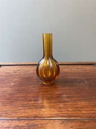 A Chinese facetted translucent amber-coloured Peking glass bottle vase, Qianlong mark, 19th C.