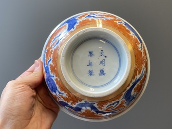 A Chinese famille rose bowl, a 'peaches' plate, a blue and white and iron-red bowl and a 'phoenix' plate, Wanli and Jiaqing marks, 19th C.