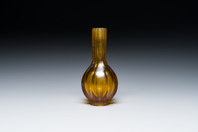 A Chinese facetted translucent amber-coloured Peking glass bottle vase, Qianlong mark, 19th C.